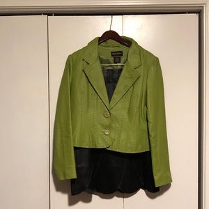 Green leather jacket with black leather skirt.